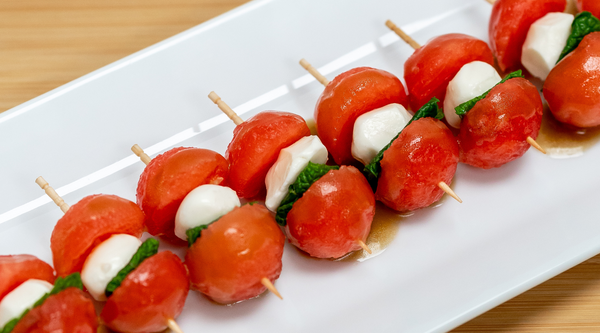 Summer finger food: Watermelon, mozzarella, and basil skewered by a toothpick.